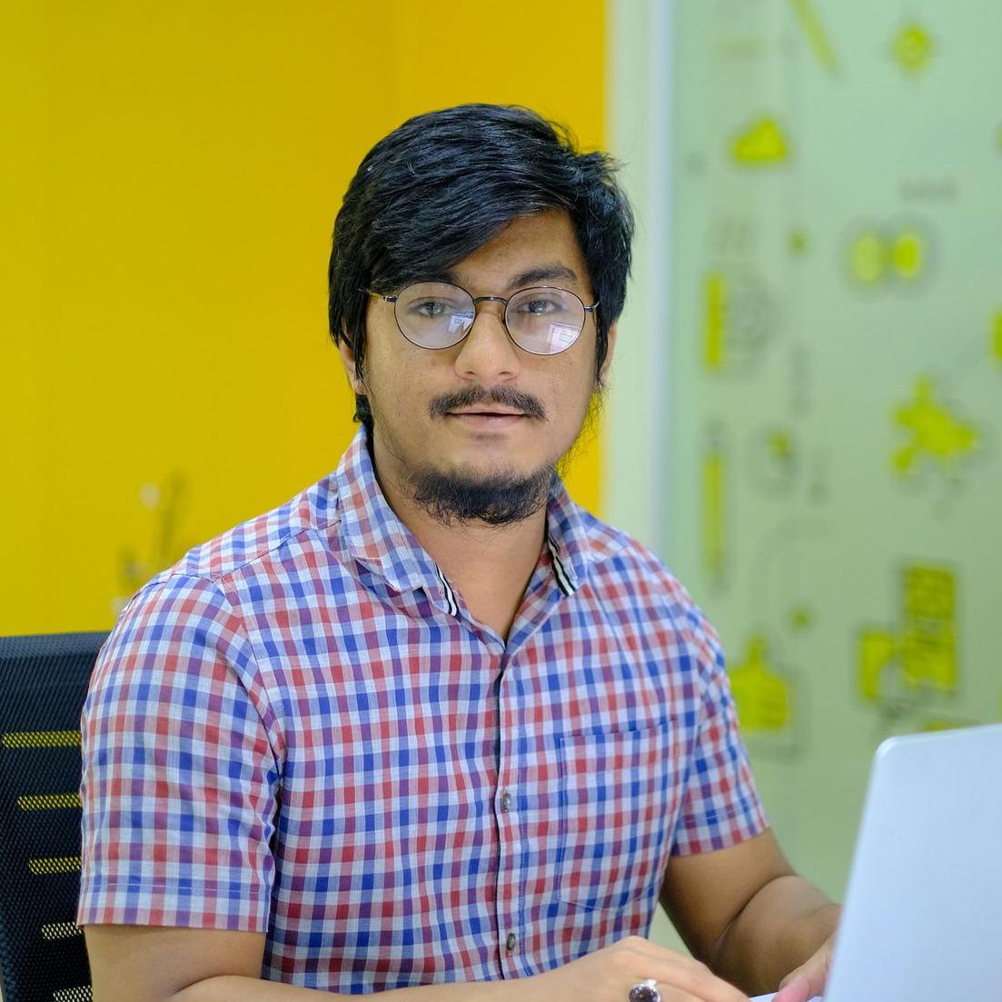 a man sitting in front of a laptop computer